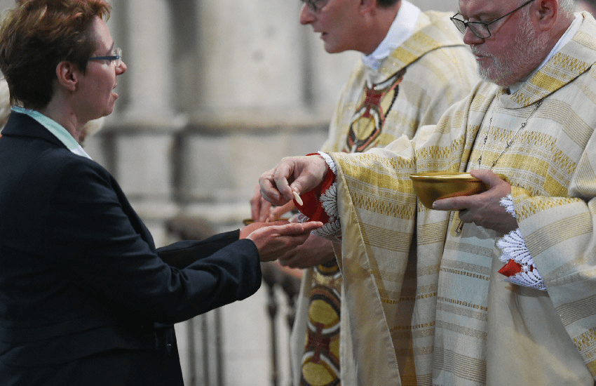 Cardinal Marx giving Communion in the hand.